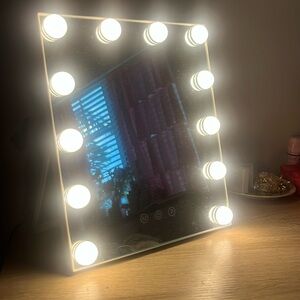 mirror with 3 different light settings. Has a cord that plugs in an outlet